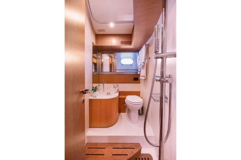 Who Cares Yacht Photos Pics Luxurious bathroom interior of 2006 Riva 68 Ego yacht, featuring modern fixtures and wooden accents.