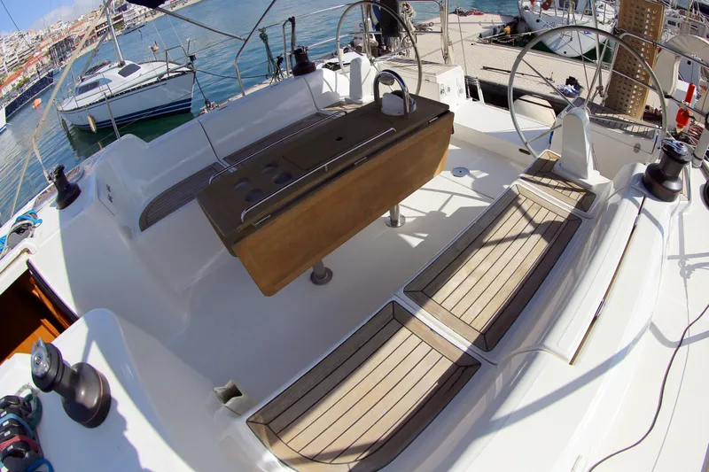  Yacht Photos Pics Dufour 425 Grand Large 2007 yacht cockpit with wooden seating and steering wheel, docked at marina.