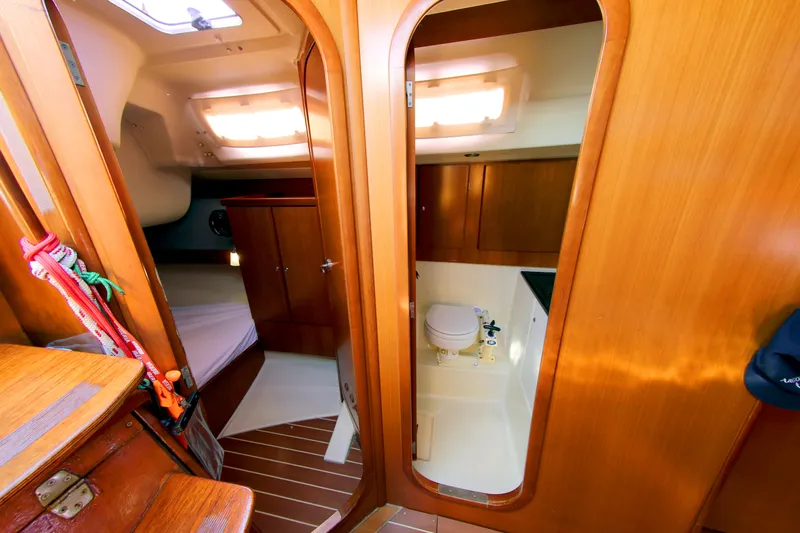  Yacht Photos Pics Interior of 2007 Dufour 425 GL yacht showing cabin and bathroom with wooden finishes.