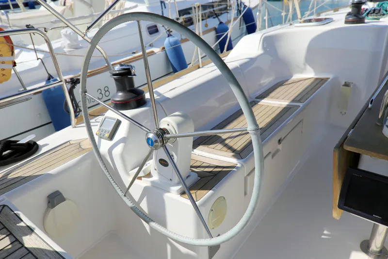  Yacht Photos Pics Steering wheel of 2007 Dufour 425 Grand Large sailboat, featuring teak deck and winches.
