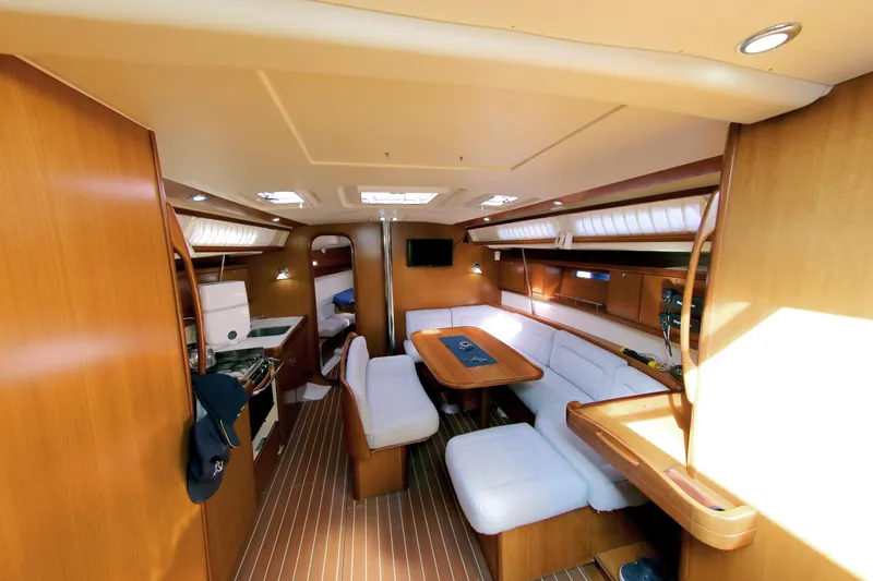  Yacht Photos Pics Interior of 2007 Dufour 425 Grand Large yacht with wood finish and white seating.