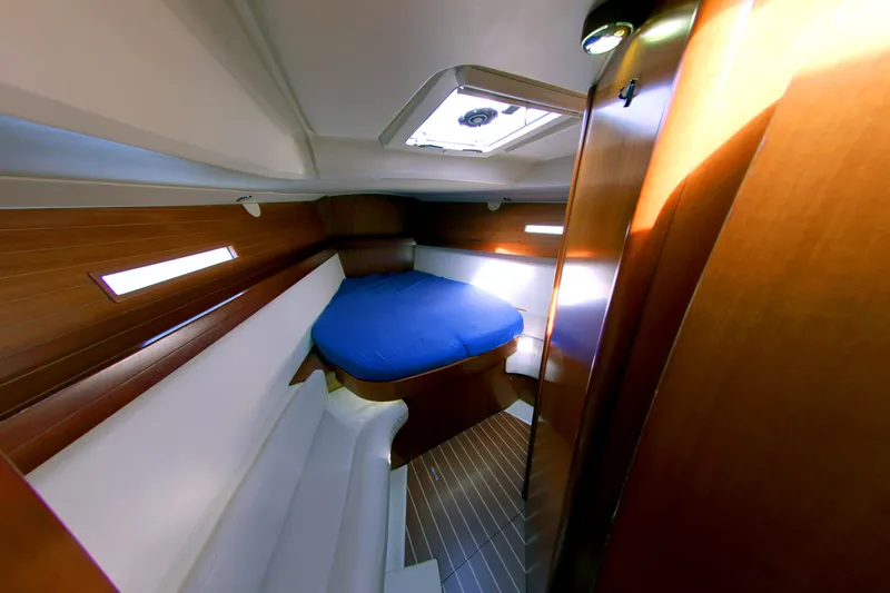  Yacht Photos Pics Interior of 2007 Dufour 425 GL yacht with cozy cabin and blue bedding.