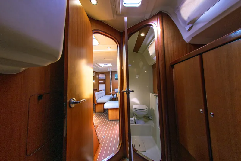  Yacht Photos Pics Interior of 2007 Dufour 425 GL yacht, featuring wooden cabinetry and a compact bathroom.
