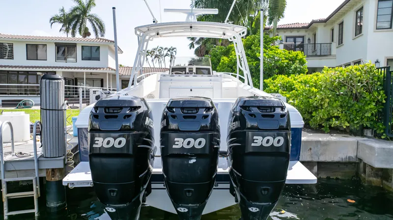  Yacht Photos Pics 2008 Intrepid 370 Cuddy with triple 300 horsepower engines docked by waterfront homes.