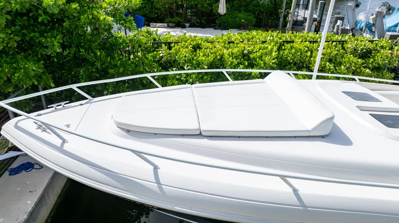  Yacht Photos Pics 2008 Intrepid 370 Cuddy boat with sleek white deck and lush greenery background.