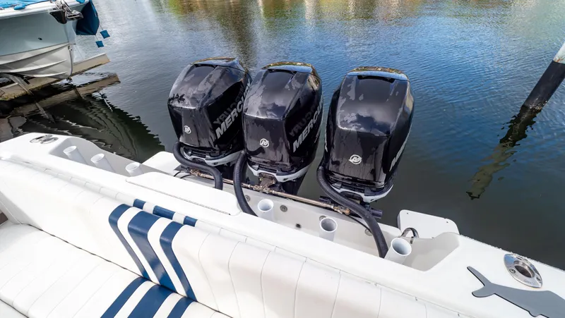  Yacht Photos Pics Triple Mercury outboard engines on a 2008 Intrepid 370 Cuddy boat, docked by the water.
