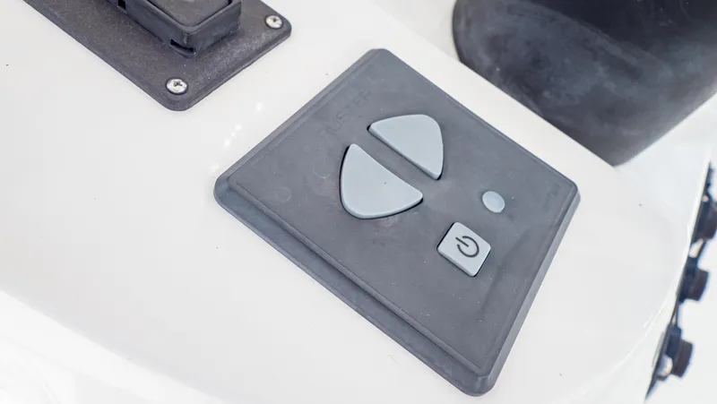  Yacht Photos Pics Control panel on a 2008 Intrepid 370 Cuddy boat, featuring arrow and power buttons.