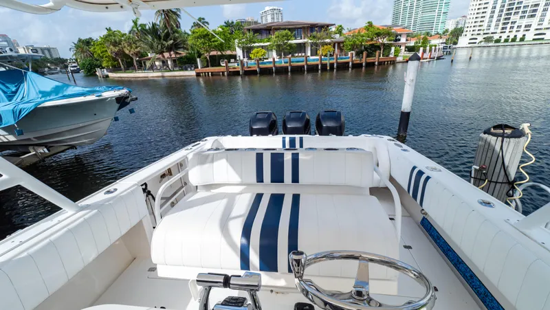  Yacht Photos Pics 2008 Intrepid 370 Cuddy boat docked in a scenic marina with waterfront views.