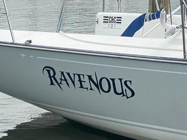 4817rf Yacht Photos Pics Sailboat named "Ravenous," Tartan 101 model, 2013, docked on calm water.