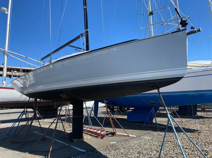 4817rf Yacht Photos Pics Sailboat on stands, Tartan 101 model, 2013, in a marina under clear blue sky.