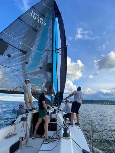 4817rf Yacht Photos Pics Sailors on Tartan 101 yacht navigating under clear skies, 2013 model.