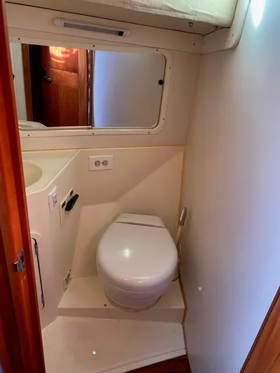 4817rf Yacht Photos Pics Compact bathroom in 2013 Tartan 101 sailboat with toilet and mirror.