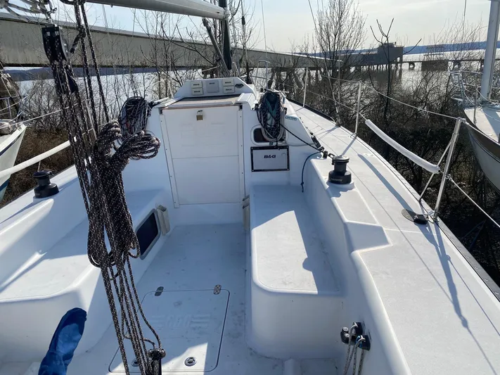 4817rf Yacht Photos Pics Tartan 101 sailboat cockpit, 2013 model, with ropes and winches, docked near water.