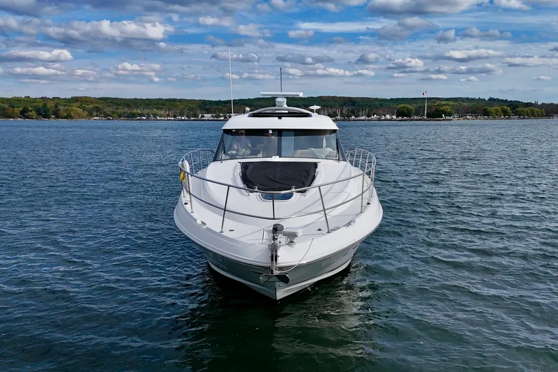 Skalywag VI Yacht Photos Pics 2015 Sea Ray 470 Sundancer yacht on a calm lake under a partly cloudy sky.