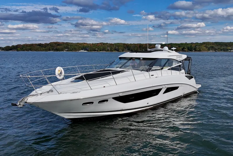 Skalywag VI Yacht Photos Pics 2015 Sea Ray 470 Sundancer yacht cruising on a serene lake under a partly cloudy sky.