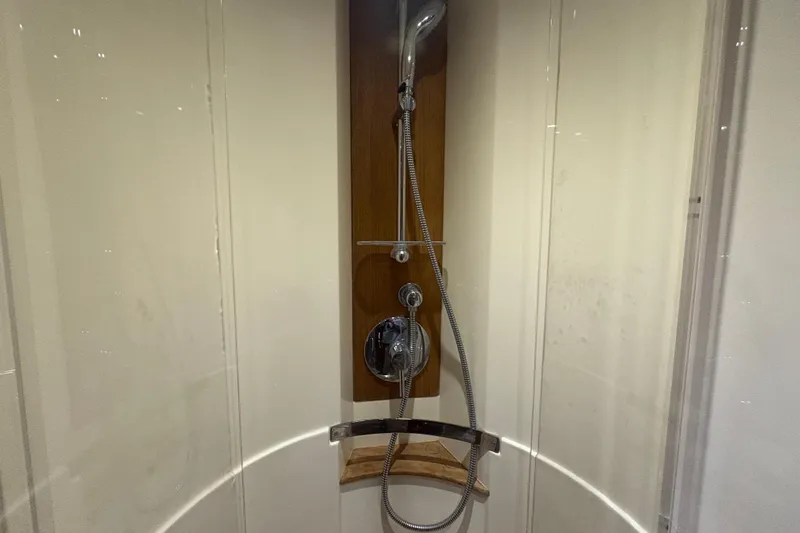 Skalywag VI Yacht Photos Pics Shower area in 2015 Sea Ray 470 Sundancer yacht, featuring modern fixtures and wood accents.