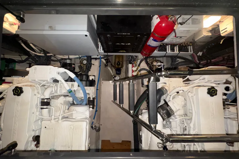 Skalywag VI Yacht Photos Pics Engine room of 2015 Sea Ray 470 Sundancer with dual engines and fire extinguisher.