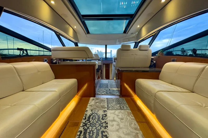 Skalywag VI Yacht Photos Pics Luxurious interior of 2015 Sea Ray 470 Sundancer yacht with panoramic windows and plush seating.