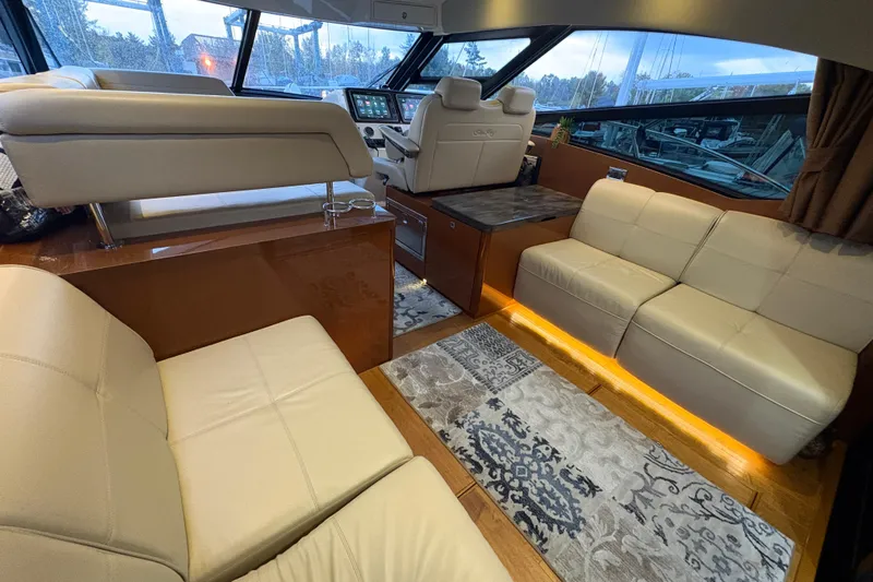 Skalywag VI Yacht Photos Pics Luxurious interior of 2015 Sea Ray 470 Sundancer yacht with plush seating and elegant decor.