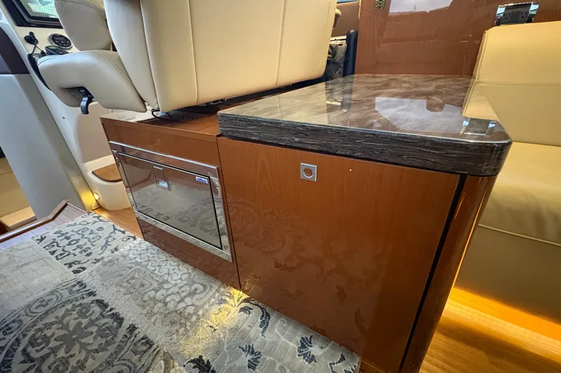 Skalywag VI Yacht Photos Pics Luxurious interior of 2015 Sea Ray 470 Sundancer with elegant wood cabinetry and seating.