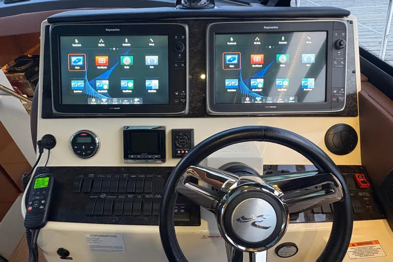 Skalywag VI Yacht Photos Pics Cockpit of 2015 Sea Ray 470 Sundancer with dual Raymarine displays and steering wheel.