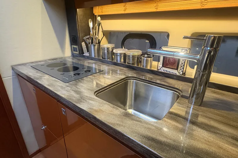 Skalywag VI Yacht Photos Pics Modern kitchen area in 2015 Sea Ray 470 Sundancer yacht with sleek sink and stove.