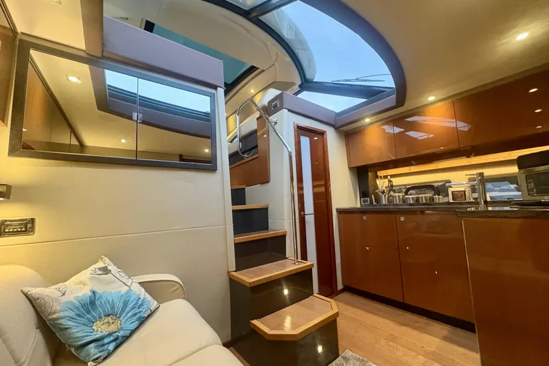 Skalywag VI Yacht Photos Pics Luxurious interior of 2015 Sea Ray 470 Sundancer yacht with modern kitchen and skylight.
