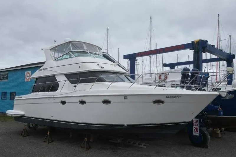  Yacht Photos Pics 2004 Carver 450 Voyager Pilothouse yacht on dry dock, overcast sky background.