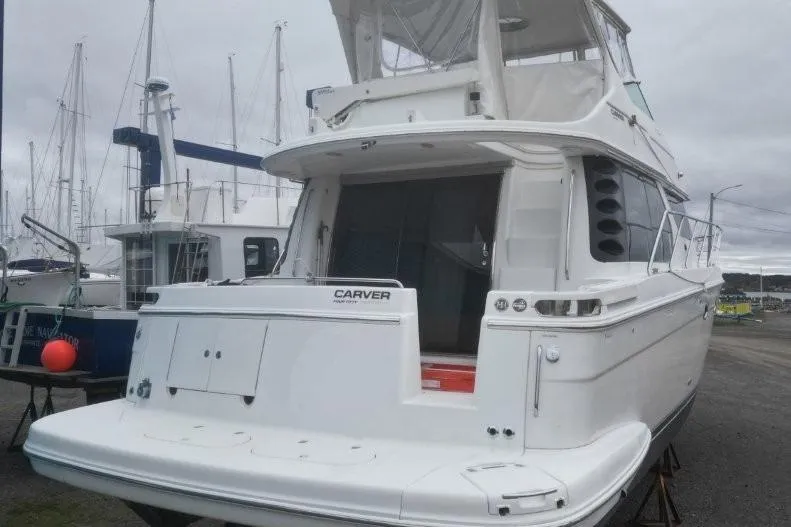  Yacht Photos Pics 2004 Carver 450 Voyager Pilothouse yacht docked at marina, rear view.