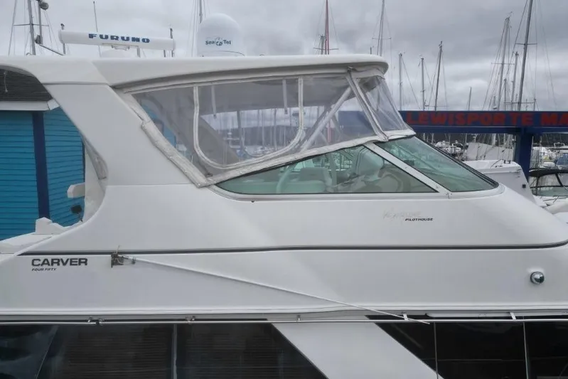  Yacht Photos Pics 2004 Carver 450 Voyager Pilothouse yacht docked at a marina under cloudy skies.