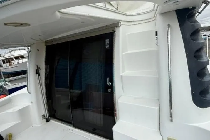  Yacht Photos Pics 2004 Carver 450 Voyager Pilothouse yacht with sliding glass door and exterior steps.