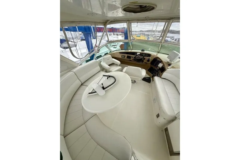  Yacht Photos Pics 2004 Carver 450 Voyager Pilothouse interior with white seating and helm controls.