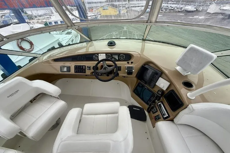  Yacht Photos Pics Pilothouse interior of 2004 Carver 450 Voyager, featuring steering wheel and navigation equipment.