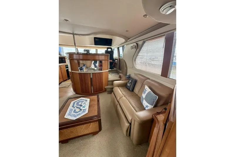  Yacht Photos Pics Interior of 2004 Carver 450 Voyager Pilothouse with leather seating and wooden accents.