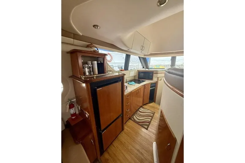  Yacht Photos Pics Interior of 2004 Carver 450 Voyager Pilothouse with wooden cabinetry and modern appliances.