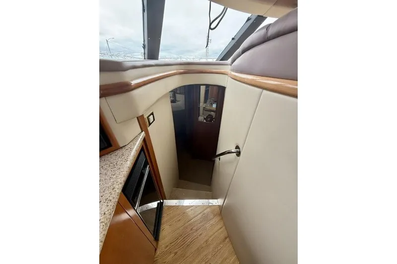  Yacht Photos Pics Stairway inside 2004 Carver 450 Voyager Pilothouse, featuring wood and leather finishes.
