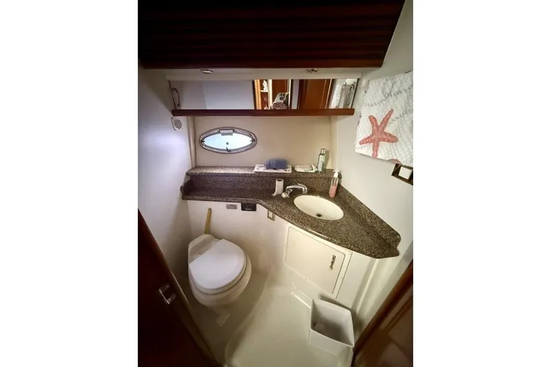  Yacht Photos Pics Bathroom in 2004 Carver 450 Voyager Pilothouse with sink, toilet, and starfish decor.