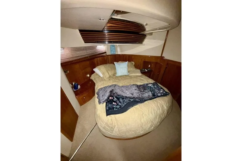  Yacht Photos Pics Luxurious bedroom interior of 2004 Carver 450 Voyager Pilothouse yacht with cozy bedding.