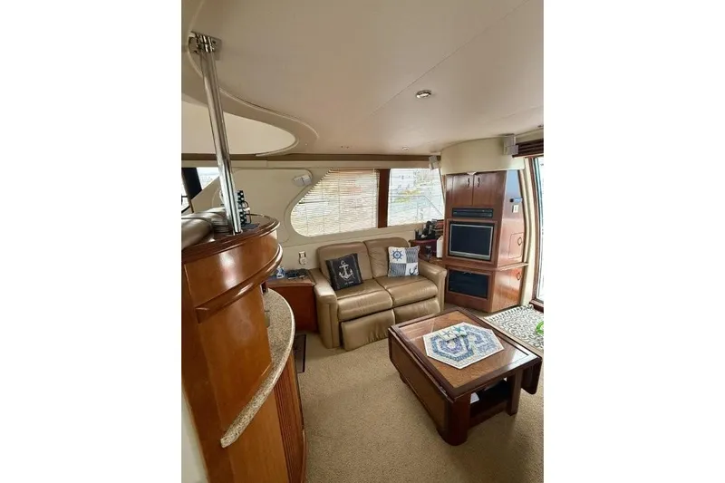  Yacht Photos Pics Luxurious interior of 2004 Carver 450 Voyager Pilothouse with leather seating and elegant wood finishes.