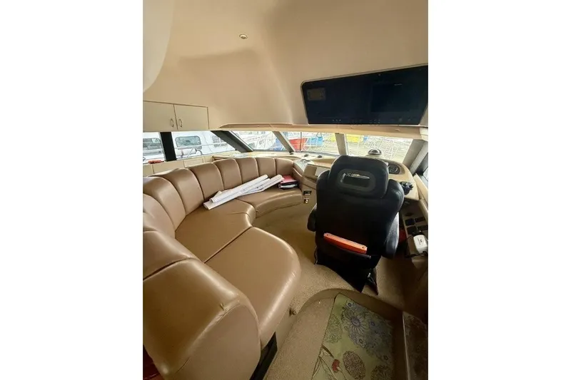  Yacht Photos Pics Interior of 2004 Carver 450 Voyager Pilothouse with tan seating and helm station.