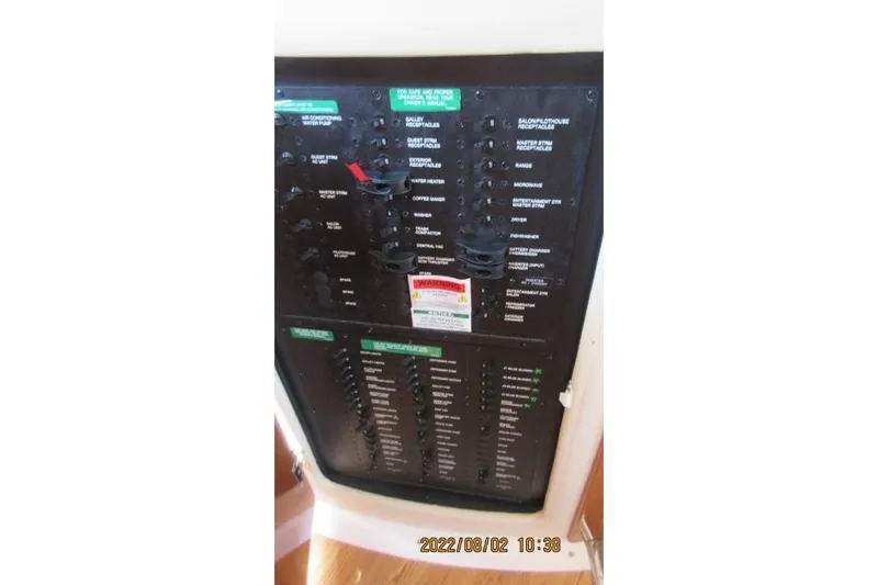  Yacht Photos Pics Electrical panel of 2004 Carver 450 Voyager Pilothouse boat, showing various switches and controls.