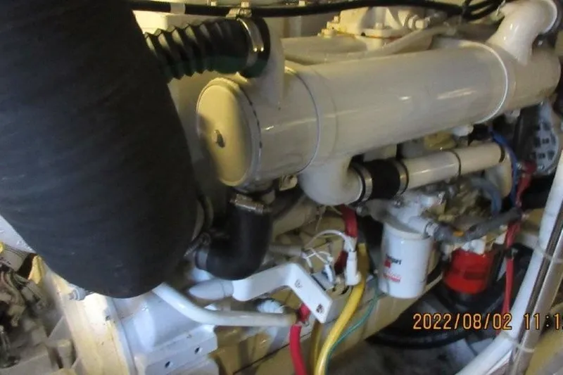  Yacht Photos Pics Engine compartment of a 2004 Carver 450 Voyager Pilothouse with visible components and hoses.