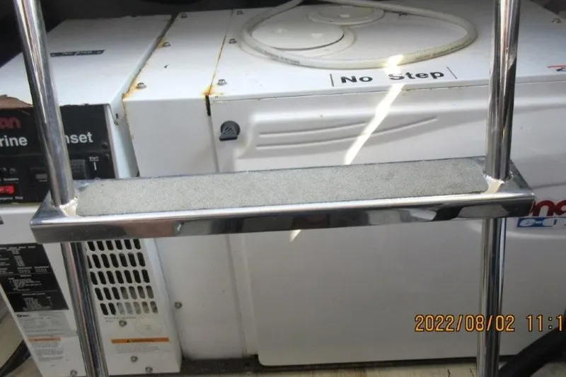  Yacht Photos Pics Engine room of 2004 Carver 450 Voyager Pilothouse with "No Step" warning sign.