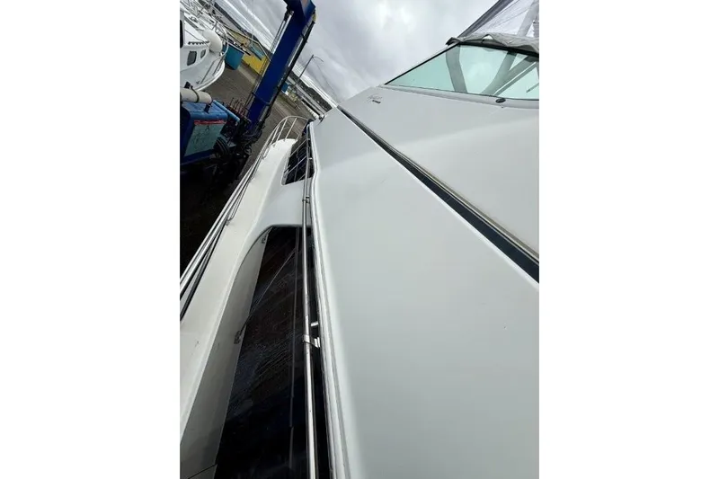  Yacht Photos Pics 2004 Carver 450 Voyager Pilothouse yacht side view, docked at marina.