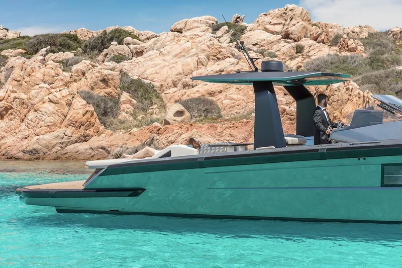  Yacht Photos Pics Luxurious 2026 Maori yacht cruising in turquoise waters near rocky coastline.