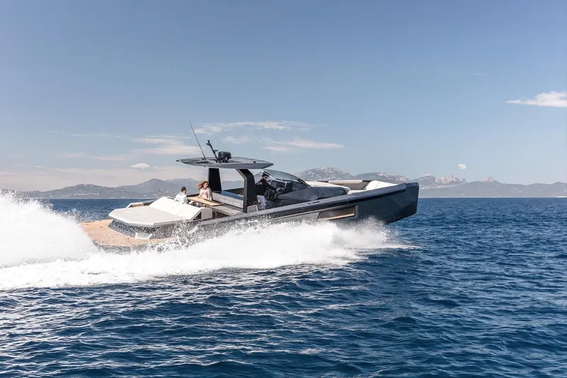  Yacht Photos Pics 2026 Maori Yacht cruising on open sea with passengers, clear sky, and distant mountains.
