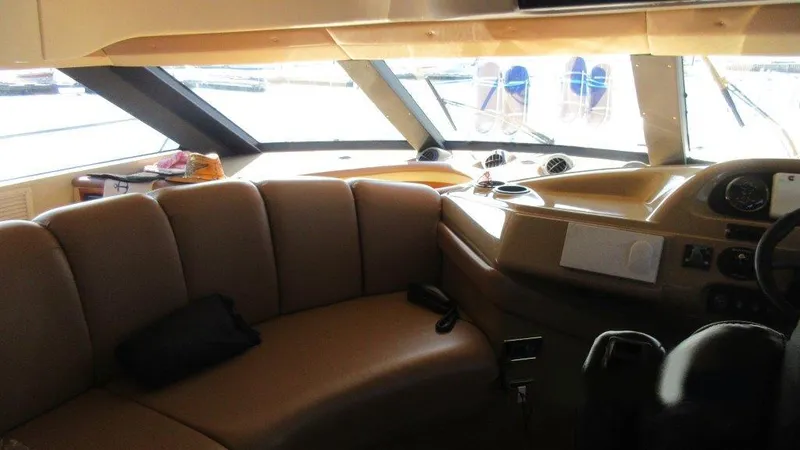  Yacht Photos Pics Interior of 2004 Carver 450 Voyager Pilothouse with leather seating and helm controls.