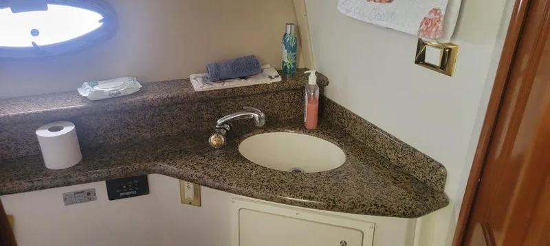  Yacht Photos Pics 2004 Carver 450 Voyager Pilothouse bathroom with granite countertop and sink.