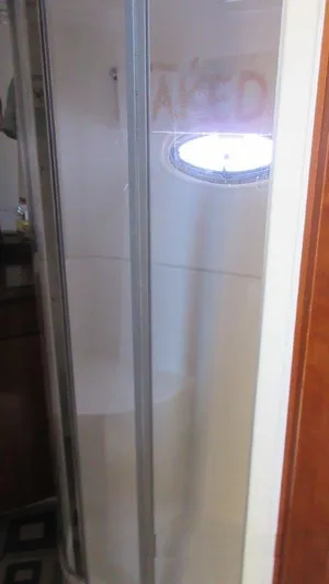  Yacht Photos Pics Shower area in 2004 Carver 450 Voyager Pilothouse yacht, featuring a sleek glass door.