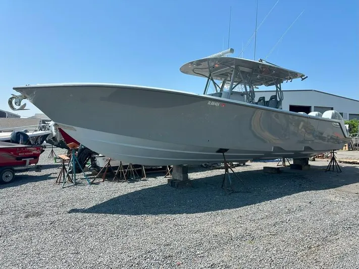 Fortuna Yacht Photos Pics 2021 SeaVee 370z boat on stands in a gravel yard, clear sky background.
